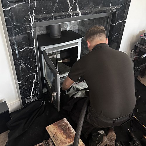 Vacuuming soot from chimney